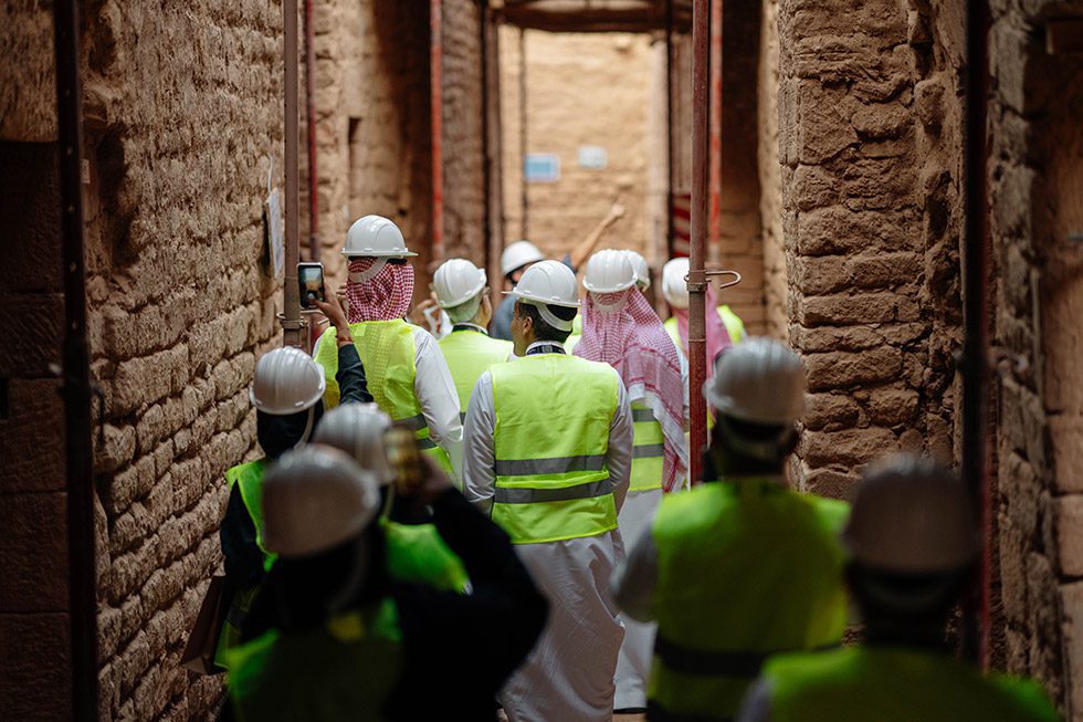 Delegates to the AlUla World Archaeology Summit tour a section of Old Town where Chronicle Heritage is supporting ongoing conservation work.