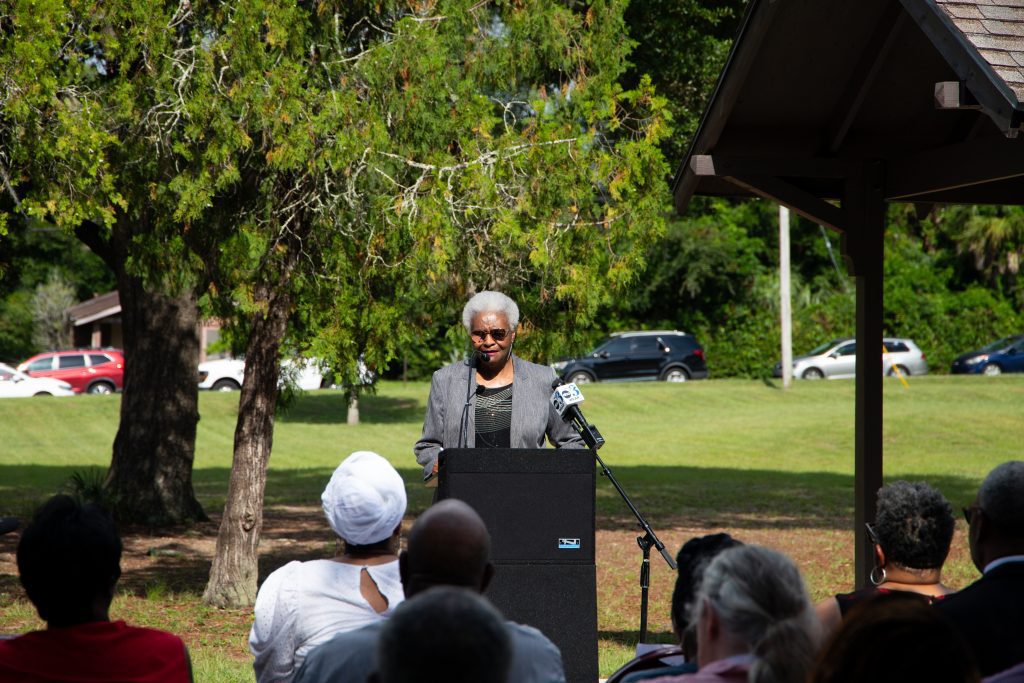 Dr. Lusharon Wiley, Chair of the Havana Square Cemetery Community Advisory Group, speaks during a dedication ceremony at Miraflores Park on June 17 where a burial marker and interpretive signage were unveiled. (Photo courtesy of the City of Pensacola)