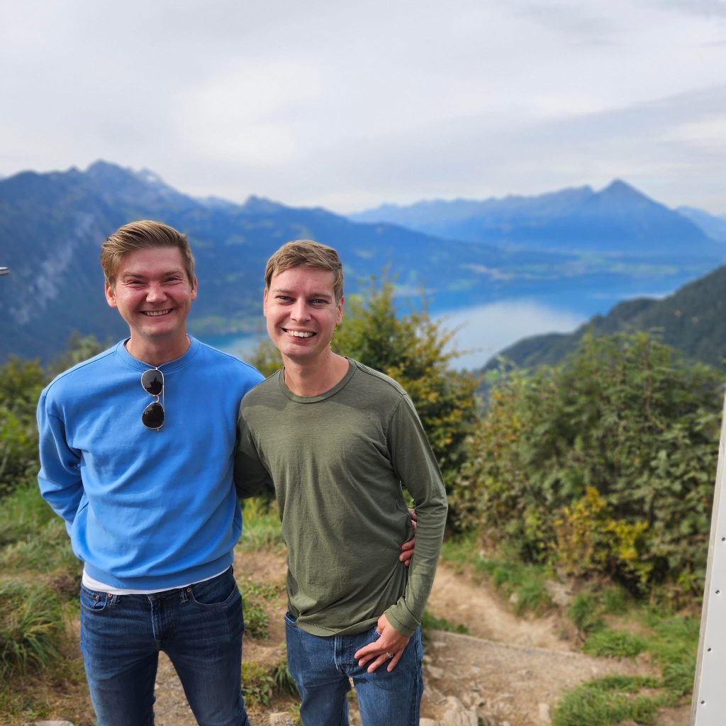 Evan McCurdy (left) poses with his husband at a scenic lookout. 