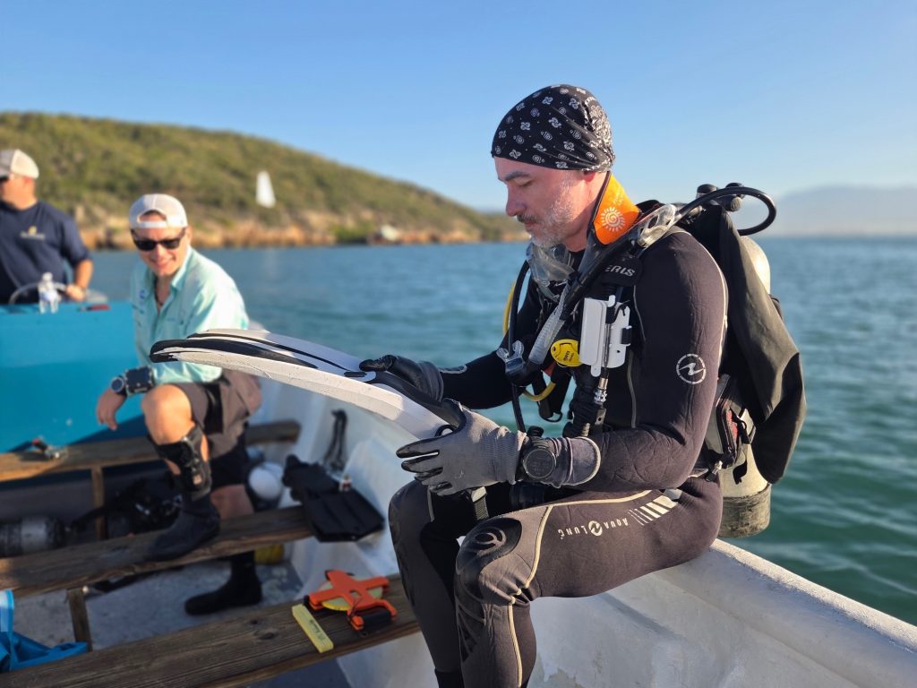 AJ Van Slyke (left), MLPJ Co-Founder and Lecturer at the University of Tennessee at Chattanooga, and William Wilson (right), Faculty Research Associate at the University of West Florida, prepare for magnetic anomaly diver investigations. Photo courtesy of Russ Matthews